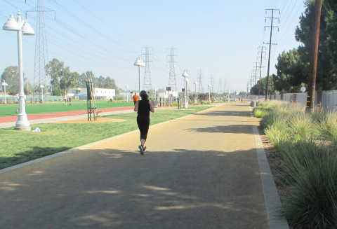 Lone runner on long shady track at Salud Park