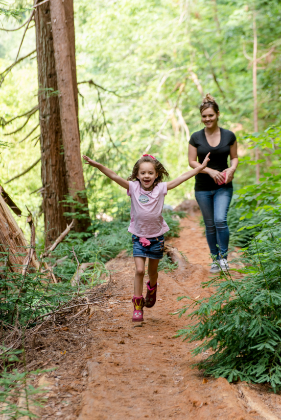 Woman and child on trail in forest